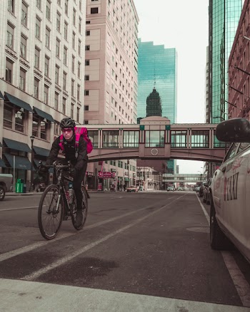 Photo of Man Riding Bicycle on the Road