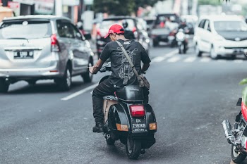 Photo of Man Riding Motorcycle on the Road