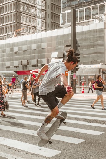 Photo of Man Riding Skateboard on Pedestrian
