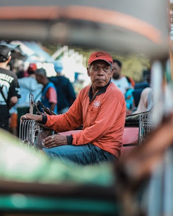 Photo of Man Sitting and Smoking Cigarette