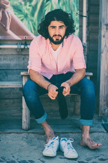 Photo of Man Sitting Down Holding Sock