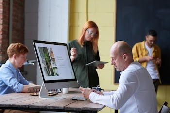 Photo Of Man Sitting In Front Of Computer