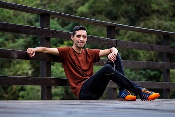 Photo of Man Sitting Near Fence