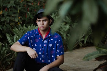 Photo Of Man Sitting Near Plants