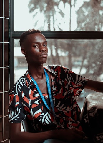 Photo Of Man Sitting Near Window