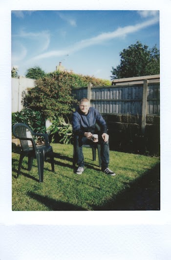 Photo of Man Sitting on Chair Holding Tea Cup