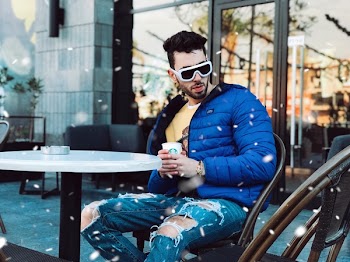 Photo of Man Sitting on Chair Posing