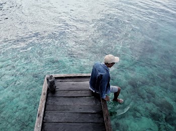 Photo of Man Sitting on Dock