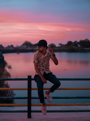 Photo Of Man Sitting On Fence