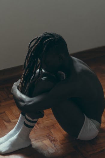 Photo of Man Sitting on Floor