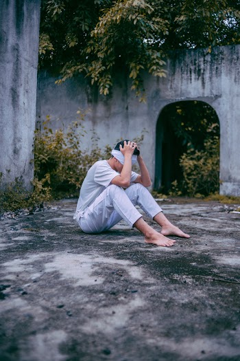 Photo Of Man Sitting on Ground