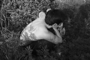 Photo of Man Sitting on Ground Near Leaves