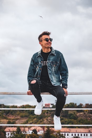 Photo Of Man Sitting On Handrail