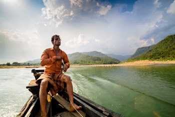 Photo of Man Sitting on Motor Boat