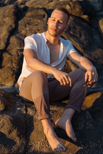 Photo Of Man Sitting On Rock