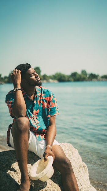 Photo Of Man Sitting On Rock 