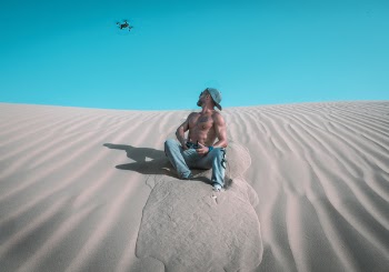 Photo of Man Sitting On Sand