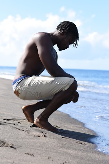 Photo of Man Sitting On Seashore