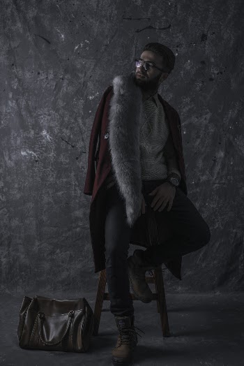 Photo of Man Sitting on Stool