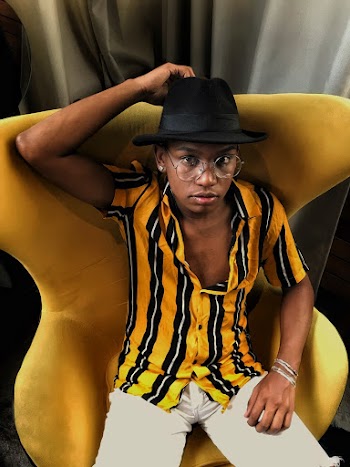 Photo of Man Sitting on Yellow Chair