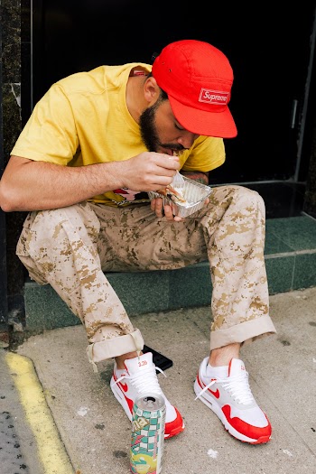 Photo of Man Sitting While Eating