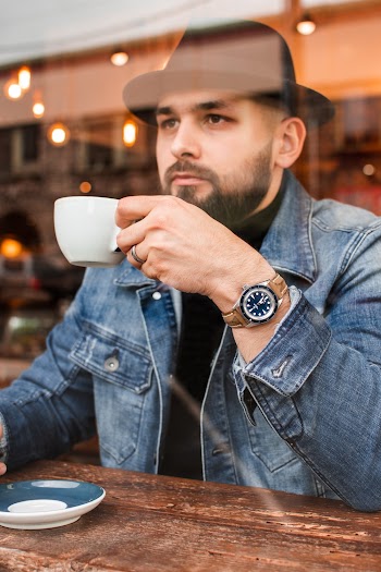Photo of Man Sitting While Holding Cup