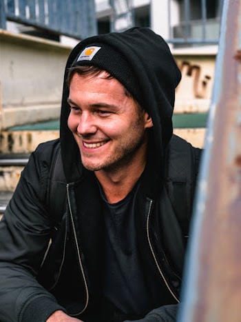 Photo of Man Smiling and Wearing Hoodie