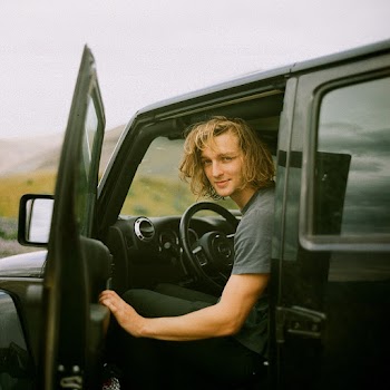 Photo of Man Smiling While Sitting in Driver's Seat