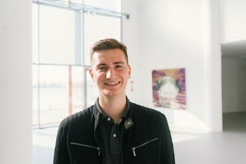 Photo of Man Smiling While Wearing Black Jacket