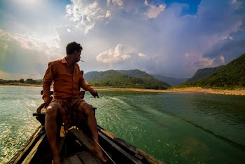 Photo of Man Smoking While Sitting on Motorboat