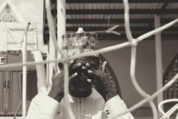 Photo of Man Standing and Covering His Eyes