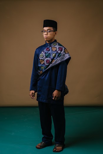 Photo of Man Standing and Wearing Eyeglasses
