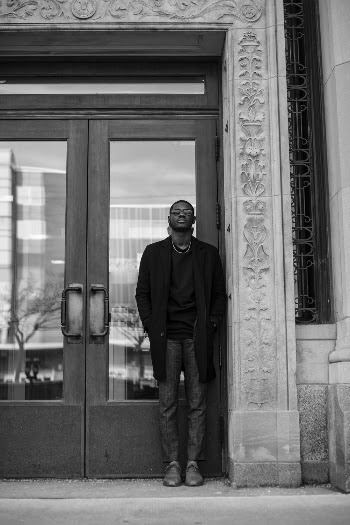 Photo Of Man Standing Beside Doorway