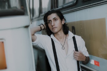 Photo of Man Standing Between Two Buses Posing