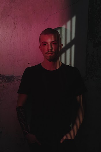 Photo of Man Standing by the Wall