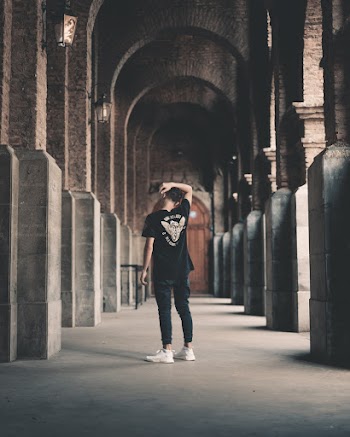 Photo of Man Standing in Hallway