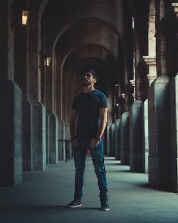 Photo of Man Standing in Hallway