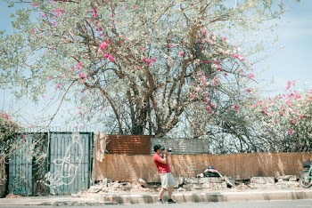Photo of Man Standing In The Middle of The Road Taking a Photo