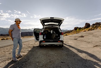 Photo of Man Standing Near a Vehicle