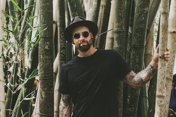 Photo of Man Standing Near Bamboo Trees