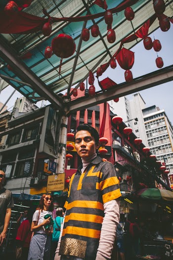 Photo of Man Standing Near Buildings