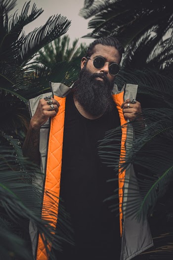 Photo of Man Standing Near Dark Green Plants