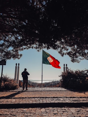 Photo Of Man Standing Near Flag