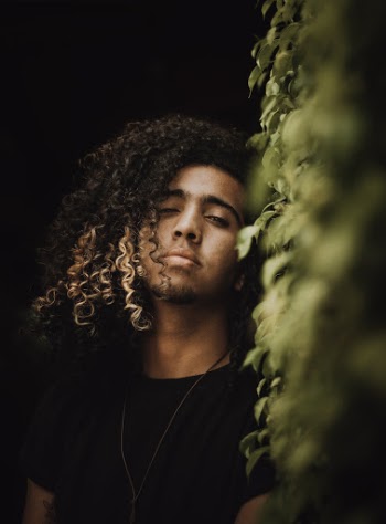 Photo of Man Standing Near Hedge