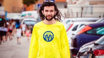 Photo of Man Standing Near Parked Vehicles