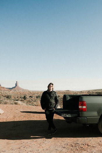 Photo of Man Standing Near Pickup Truck