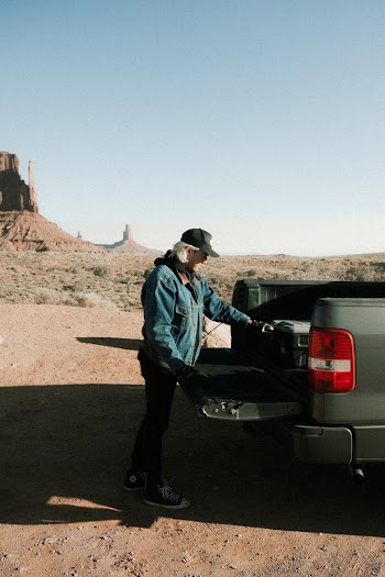Photo of Man Standing Near Pickup Truck