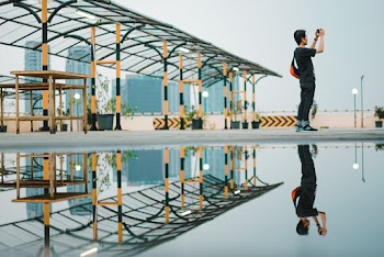 Photo of Man Standing Near Puddle