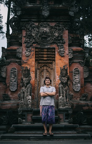 Photo of Man Standing Near Sculptures