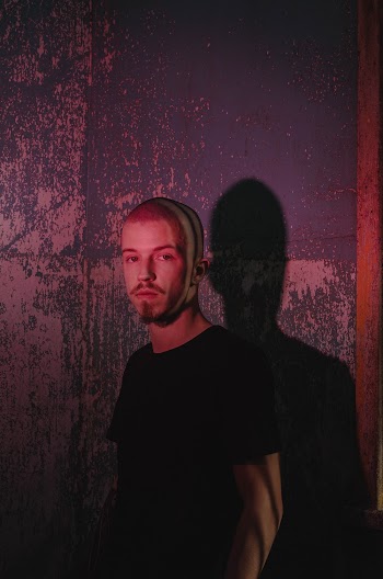 Photo of Man Standing Near the Wall